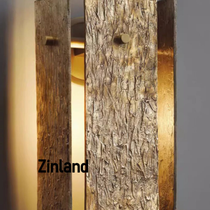 Detailed view of a textured brass wall sconce, highlighting its warm golden finish and artistic craftsmanship.