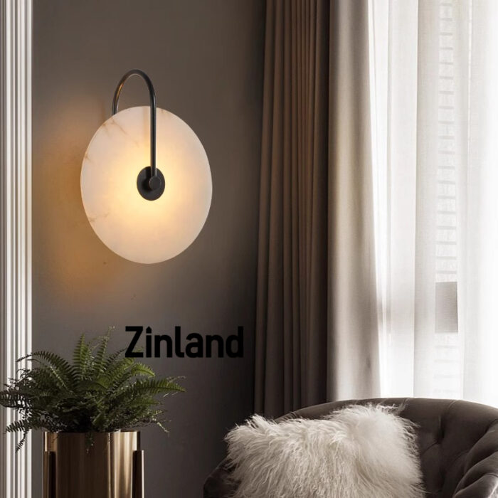 Luxury black alabaster wall lamp with a curved black metal arm, creating warm ambient lighting in a stylish living room.